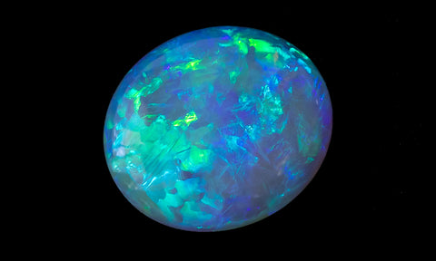 Australian opal from Lightning Ridge known as a black opal coloured green and blue