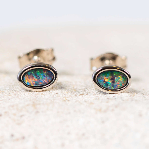 Classic sterling silver stud earrings bezel set with multi-coloured oval Australian triplet opals.